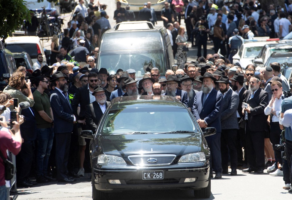Mourners attend the funeral of Rabbi Eli Schlanger, who was killed during a shooting at a Jewish Hanukkah celebration at Sydney's Bondi Beach on Sunday