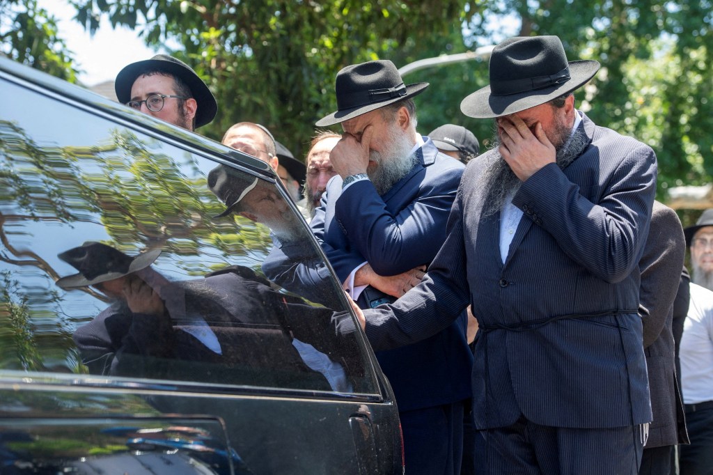Mourners escort the coffin of Rabbi Eli Schlanger at Chabad of Bondi synagogue, in Sydney, Australia.