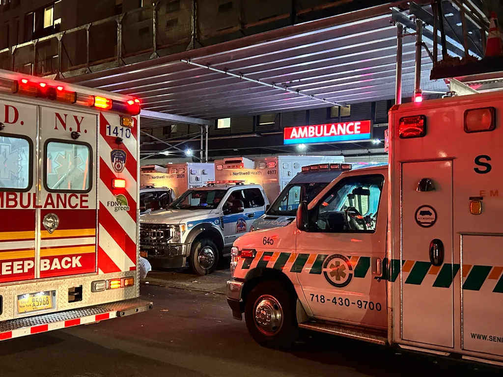 Multiple ambulances parked outside the emergency room entrance at Forest Hills Hospital.