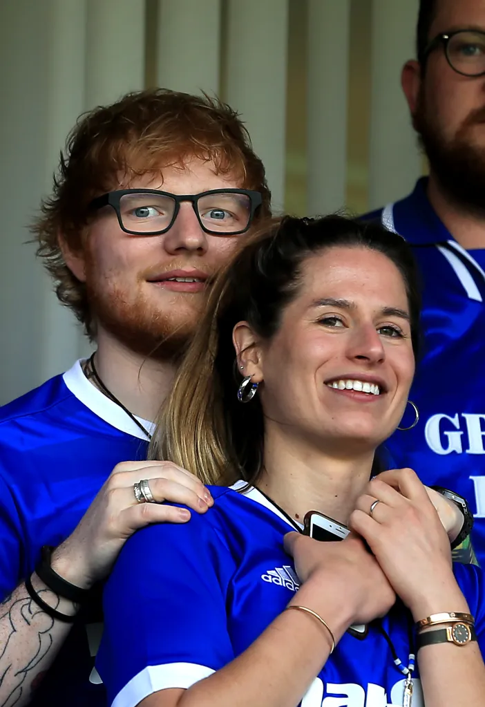 Musician Ed Sheeran and wife Cherry Seaborn look on during an Ipswich Town football match.