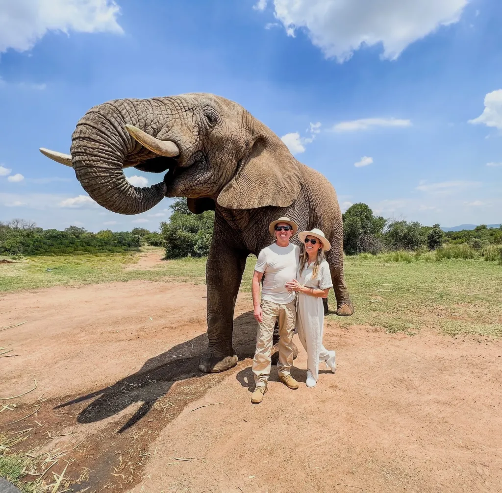 NASCAR driver Greg Biffle poses with his family and an elephant.