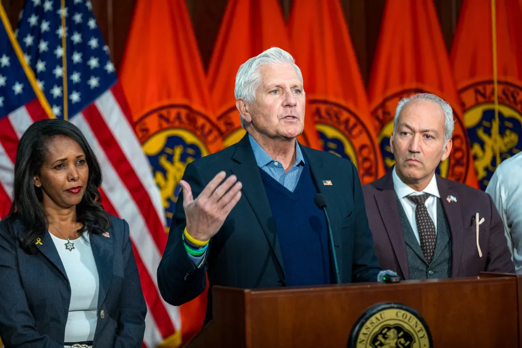 Nassau County Executive Bruce Blakeman and Legislator Mazi Pilip, along with other men, at a press conference.