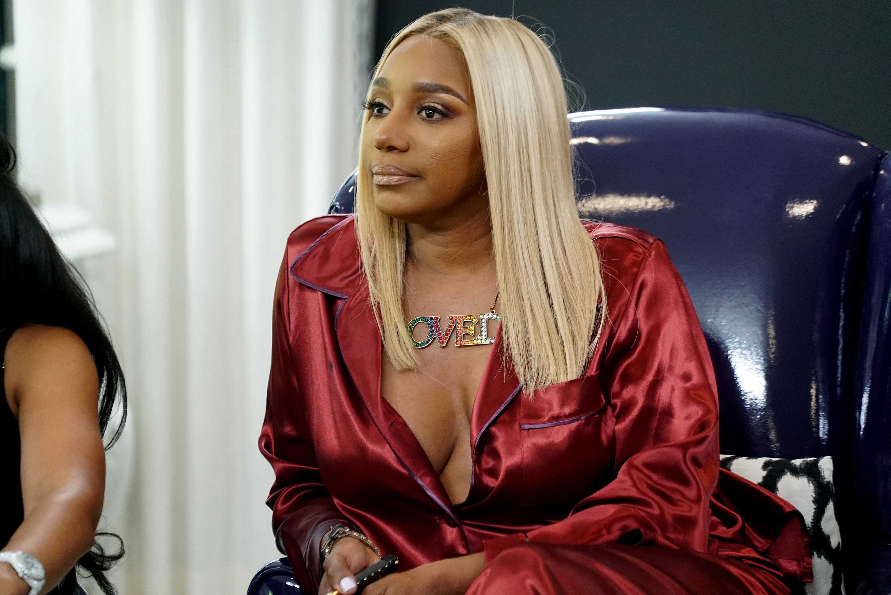 NeNe Leakes in a red satin top and a colorful