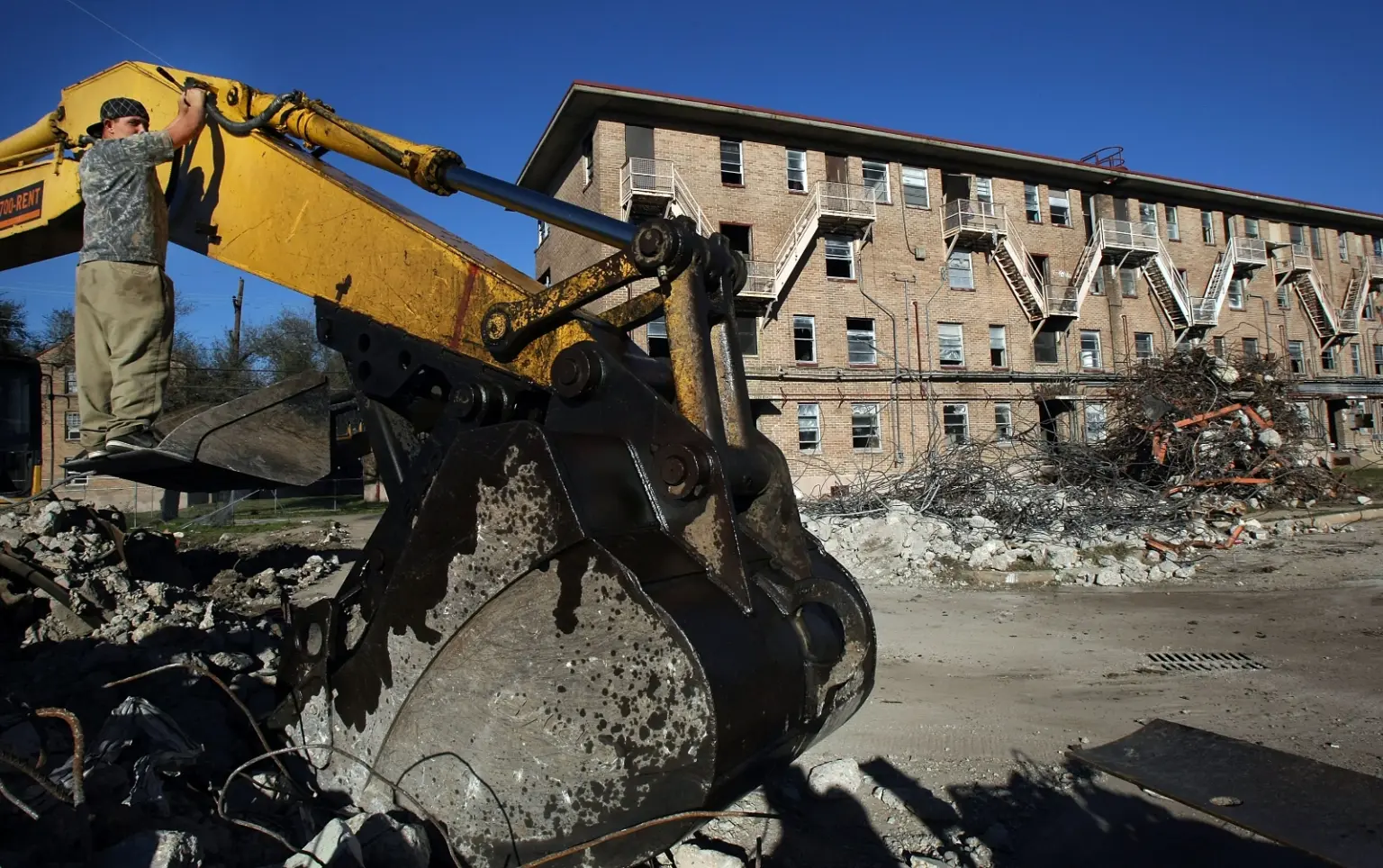 A giant truck preparing for demolition of a public housing development