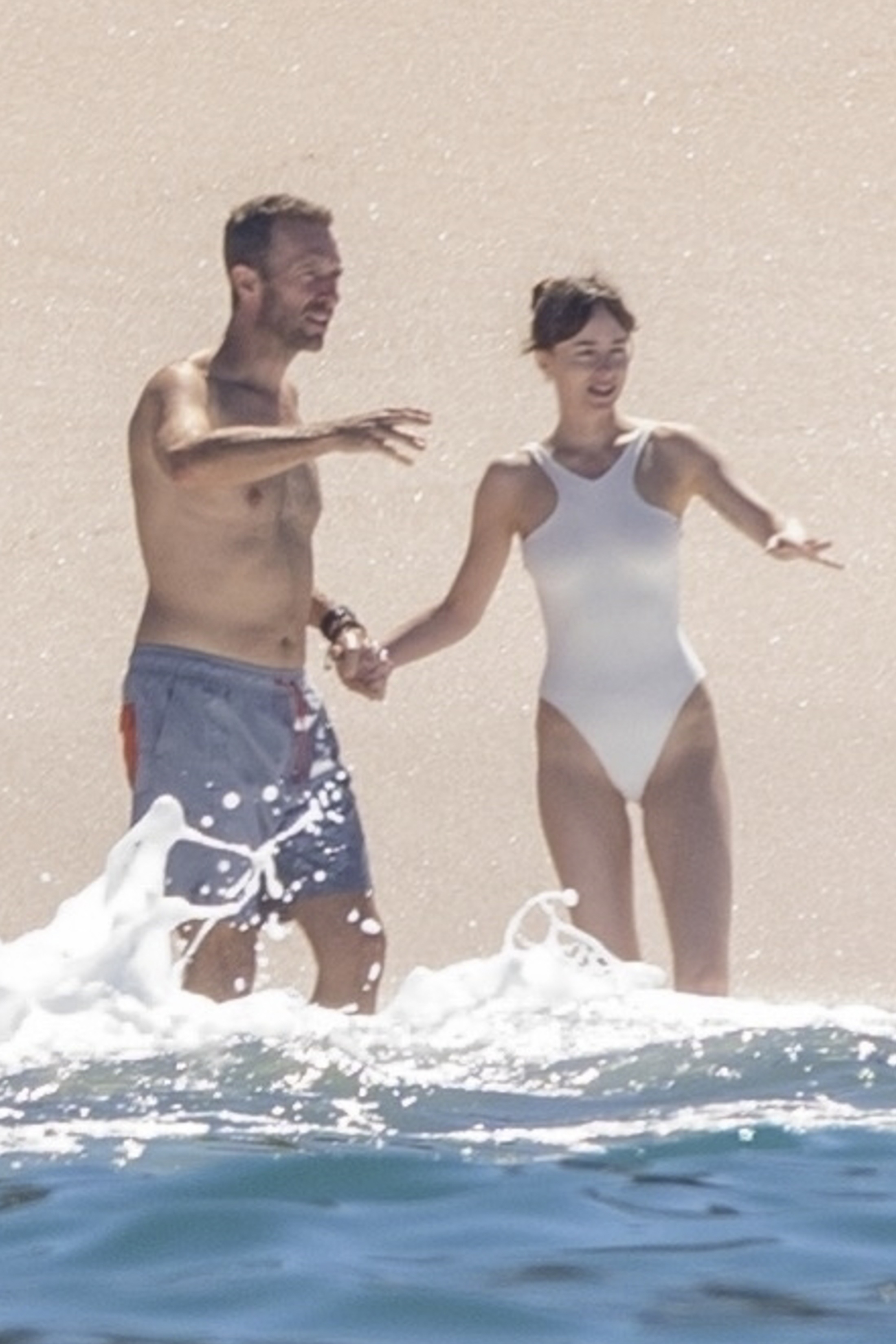 Dakota Johnson and Chris Martin relaxing on a beach in Puerto Vallarta, Mexico.