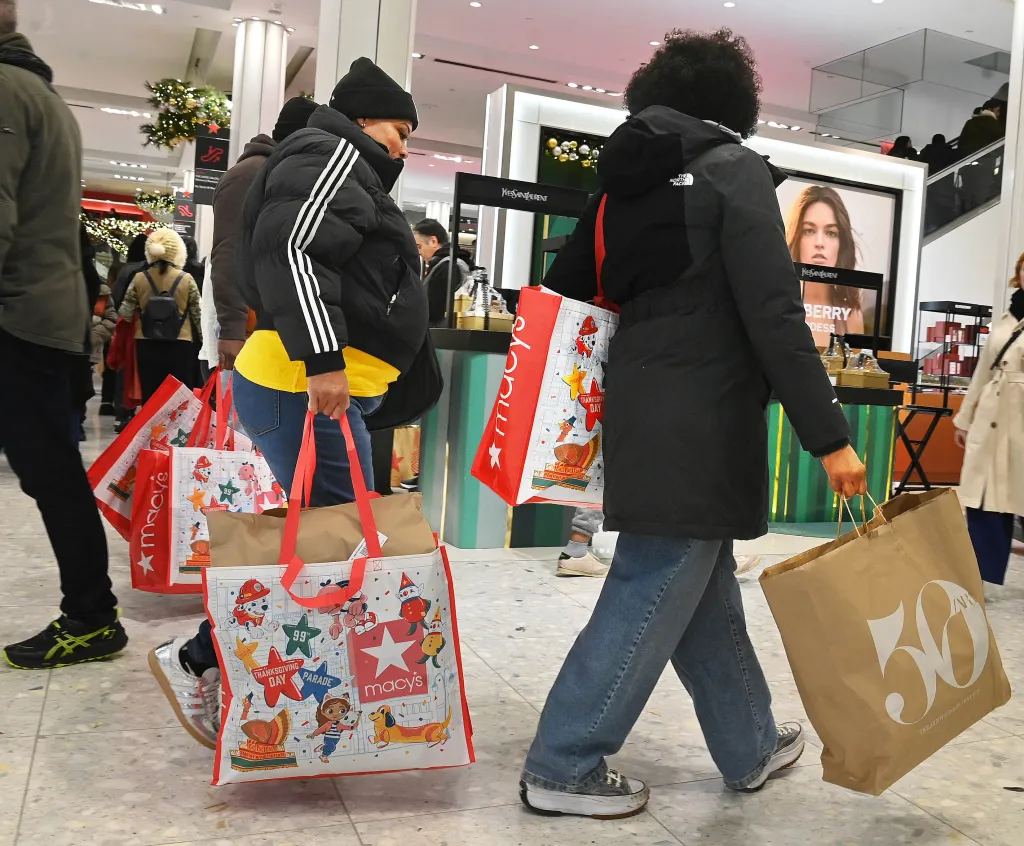 Shoppers carrying Macy's and other store bags on Black Friday.