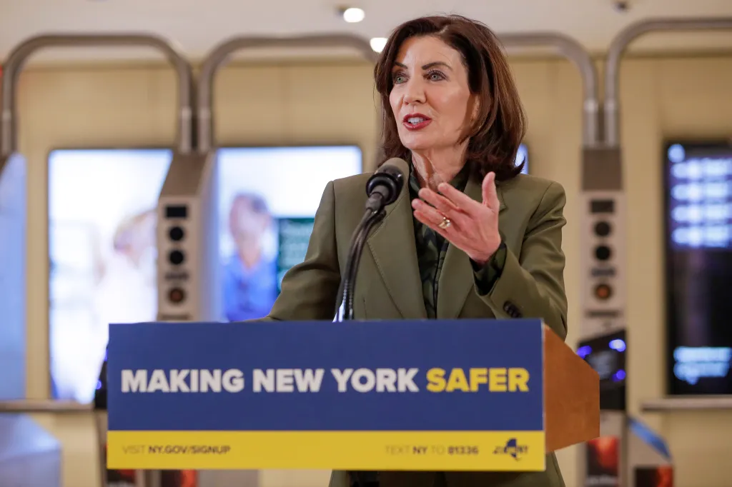 New York State Governor Kathy Hochul speaks at a podium with 