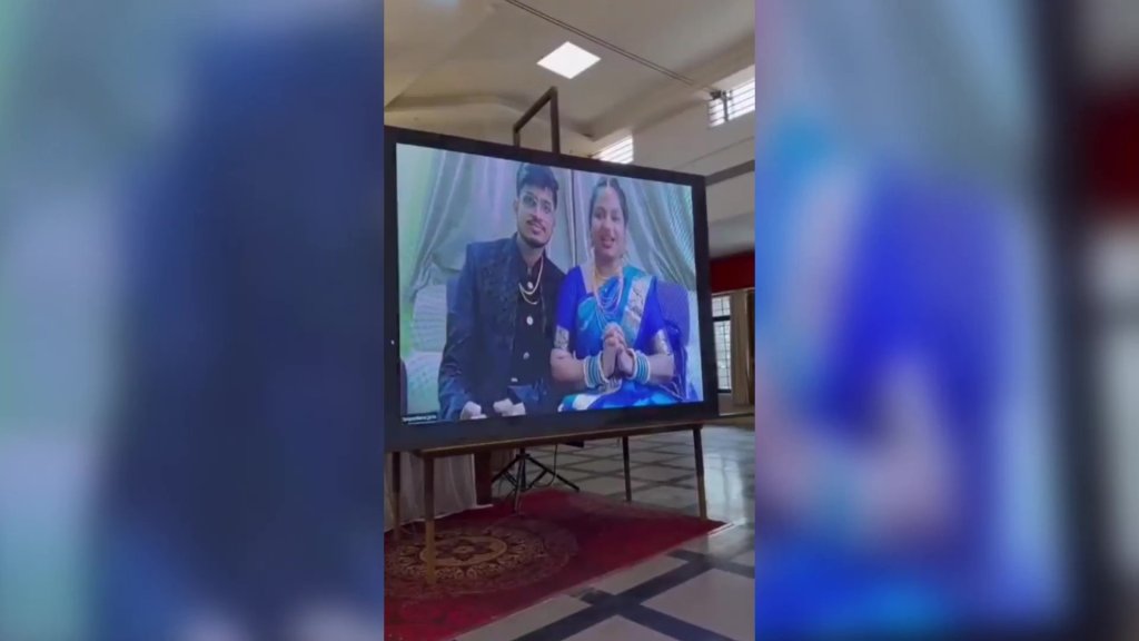 The couple were displayed live on a huge screen so they could participate from hundreds of miles away. 