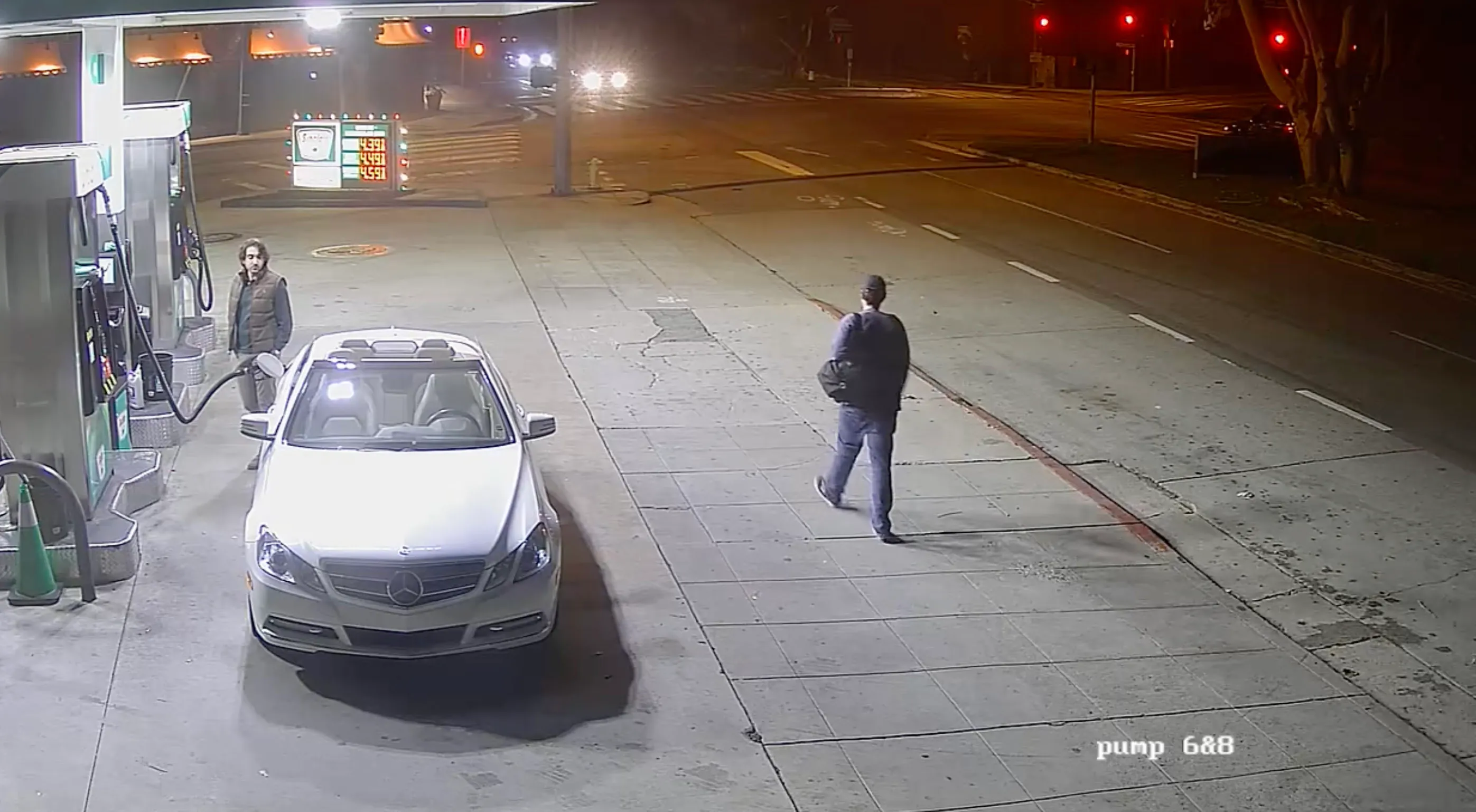 Nick Reiner walks by a gas station at night.