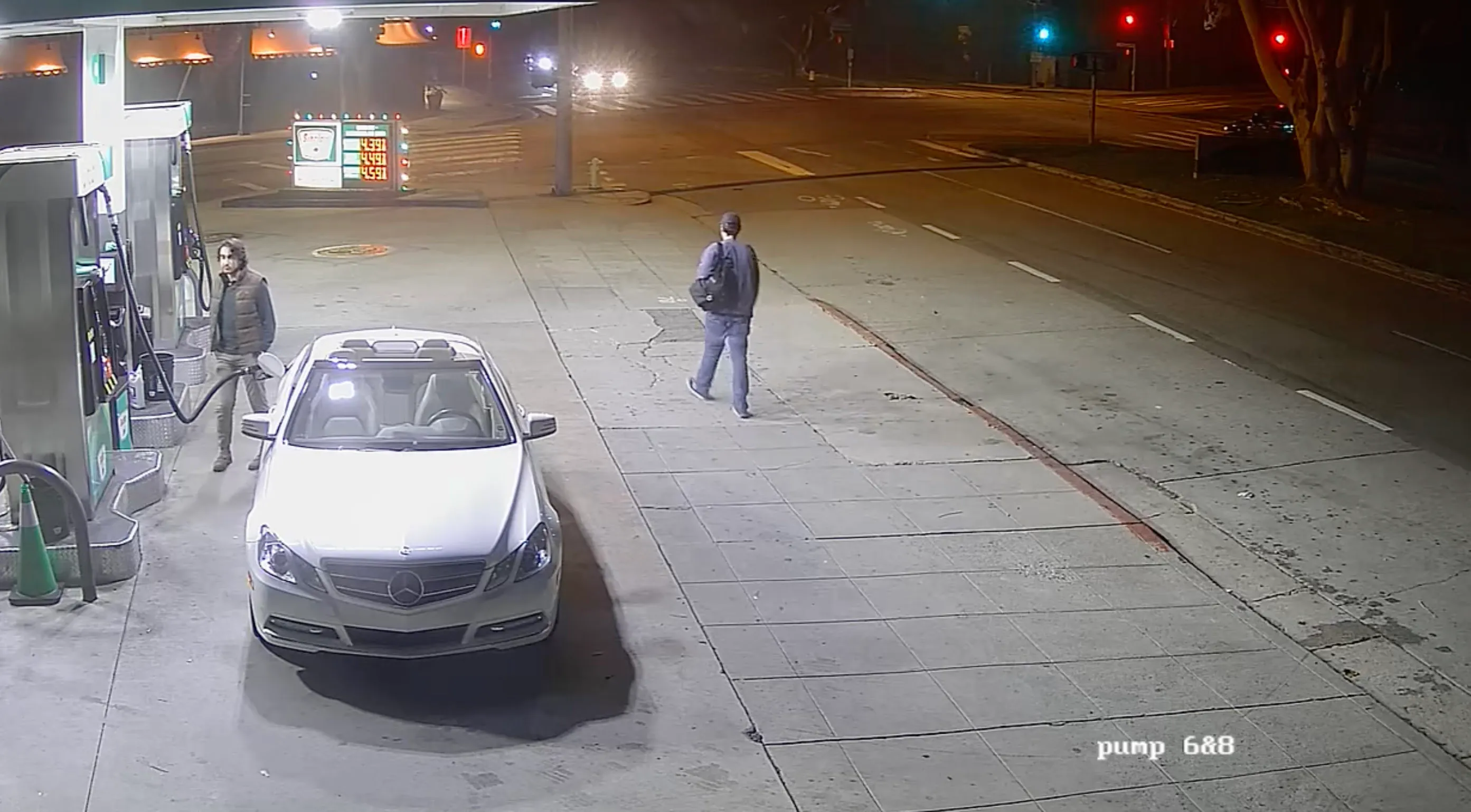 Nick Reiner walks by a gas station at night.