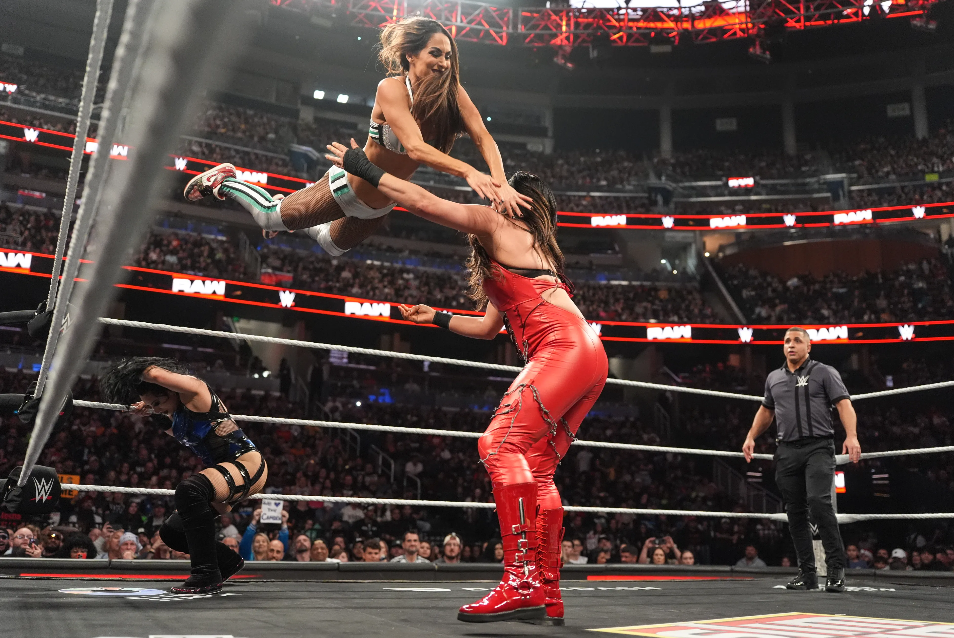 Nikki Bella performing a Cross Body move on Raquel Rodriguez during Monday Night RAW.