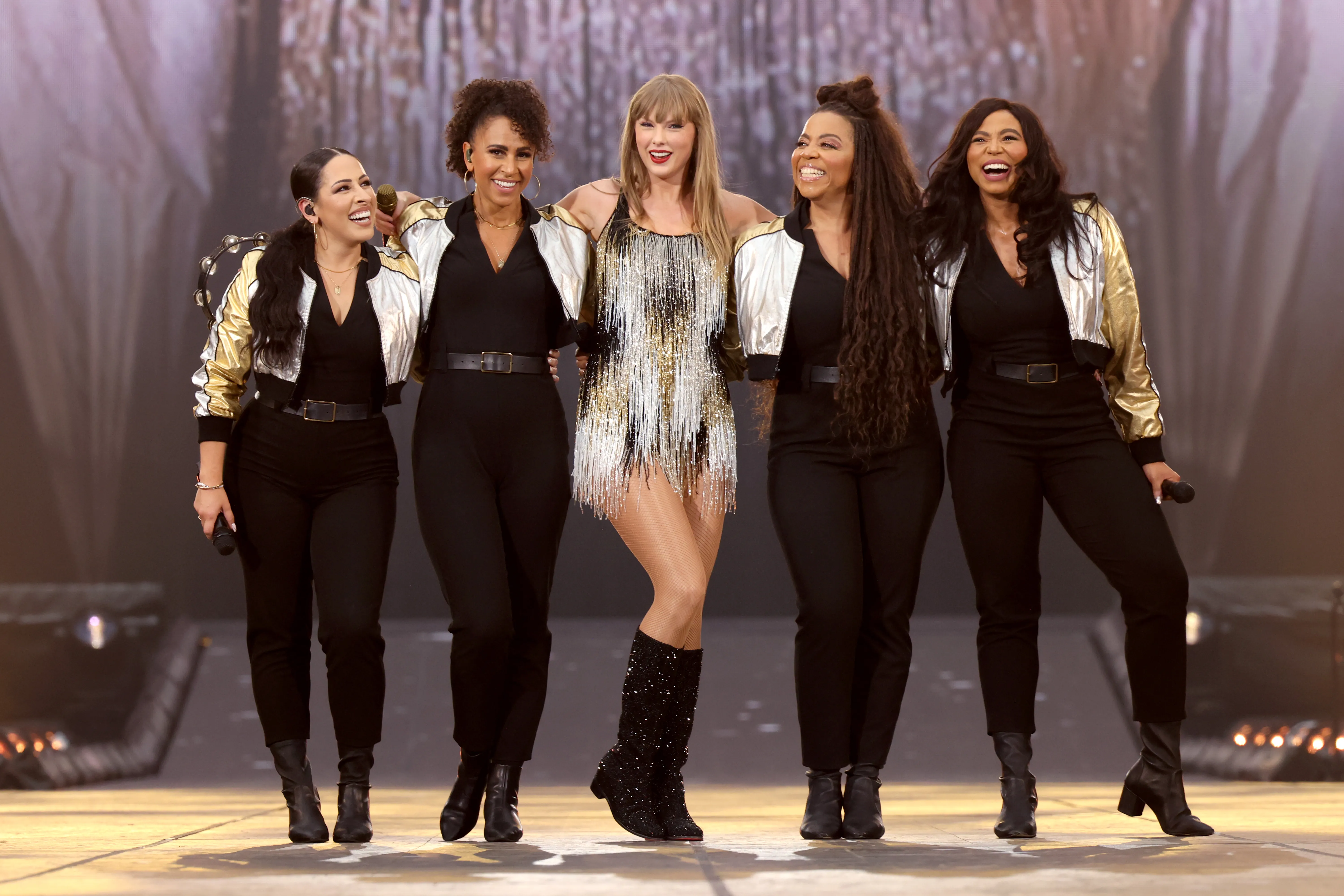 Taylor Swift performing with her background singers on