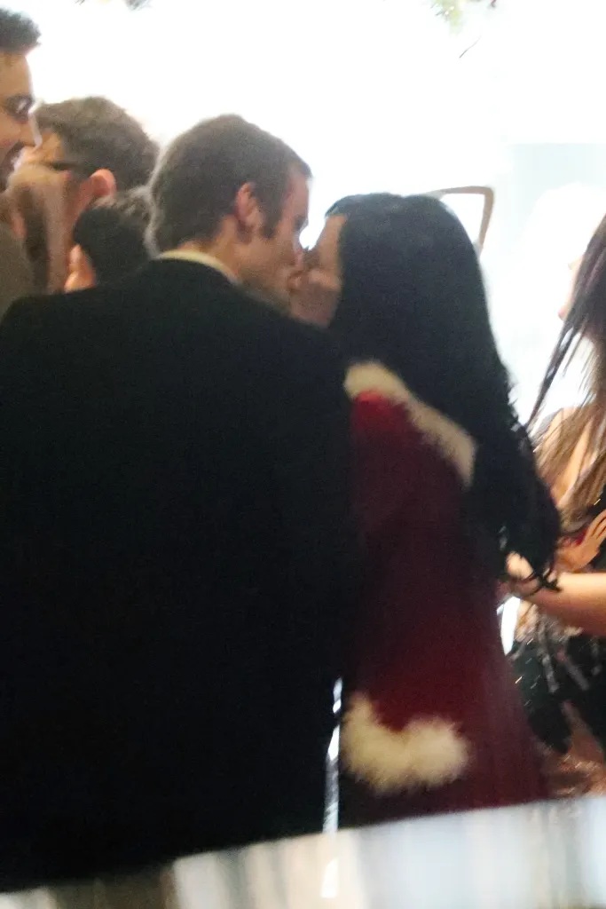 Jonah Freud and Lily Allen kissing at a Christmas party.