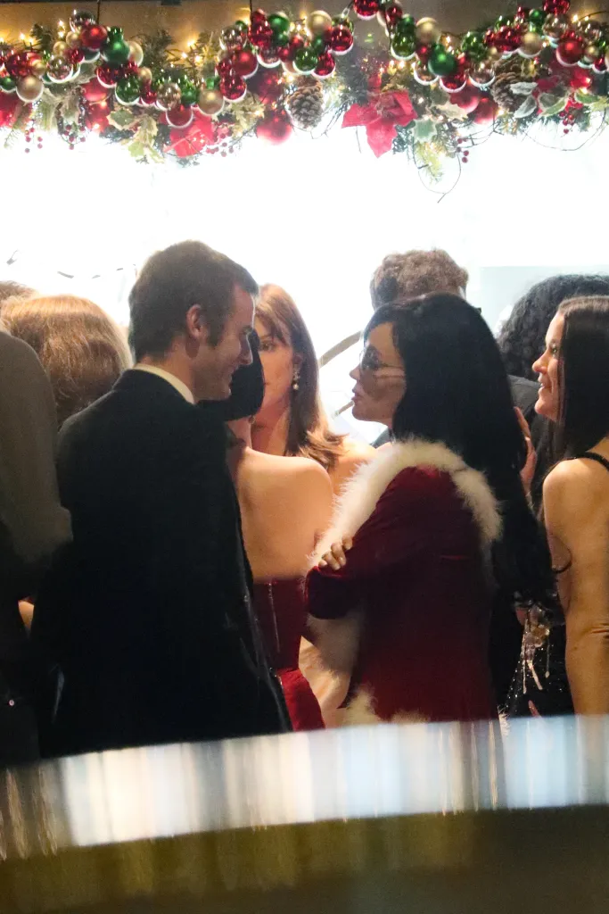 Jonah Freud and Lily Allen kissing at a Christmas party.