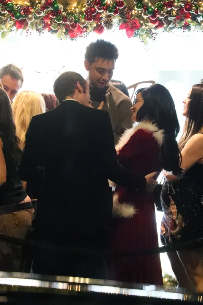 Lily Allen and Jonah Freud kissing at a Christmas party.