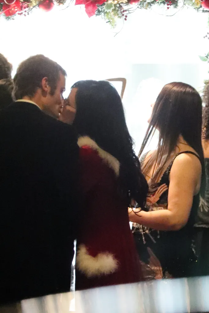 Lily Allen and Jonah Freud kissing at a Christmas party.