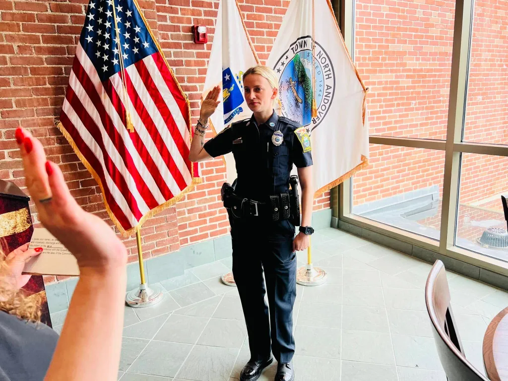 North Andover officer Kelsey Fitzsimmons taking an oath with her right hand raised.