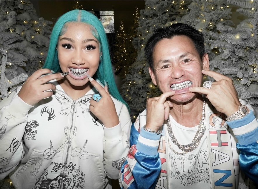 North West and a man showing off diamond grills.
