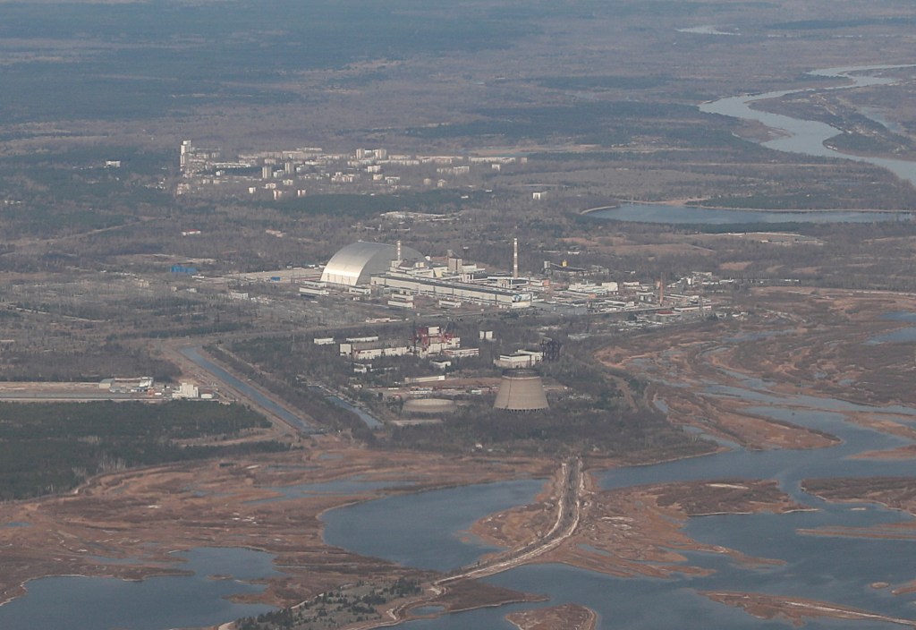 Aerial view of the Chernobyl Nuclear Power Plant with the New Safe Confinement structure and the Pripyat River.