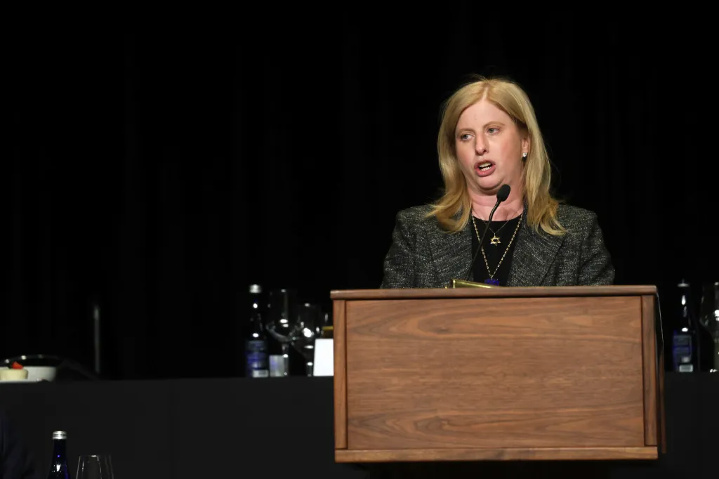 Jessica Tisch at a podium, receiving the