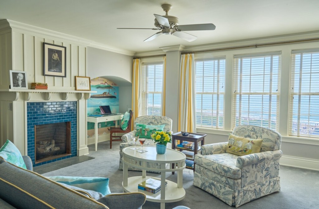 An elegant living room at Ocean House Rhode Island with a view of the ocean.