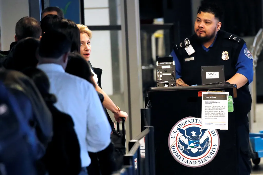 A Transportation Security Administration (TSA) officer checks passengers into security at LaGuardia Airport in New York January 25, 2019.