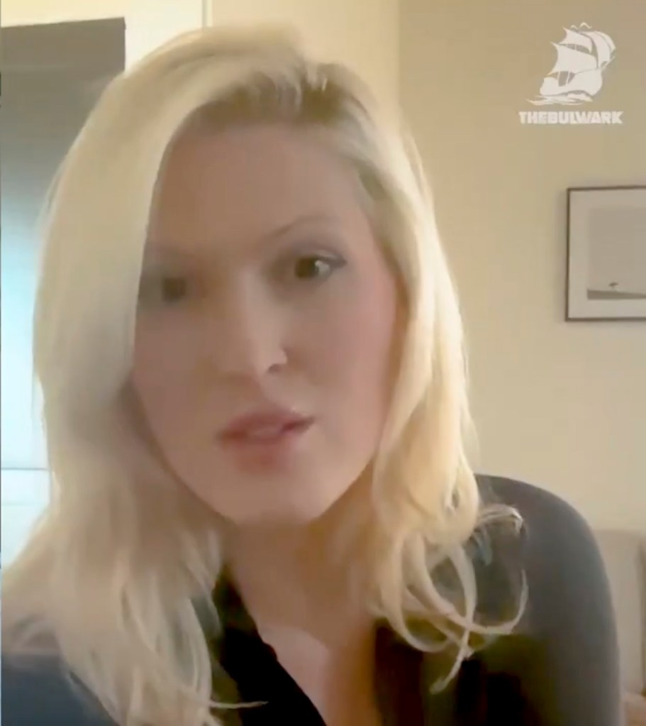 Olivia Nuzzi with blonde hair and a black top, speaking into the camera.