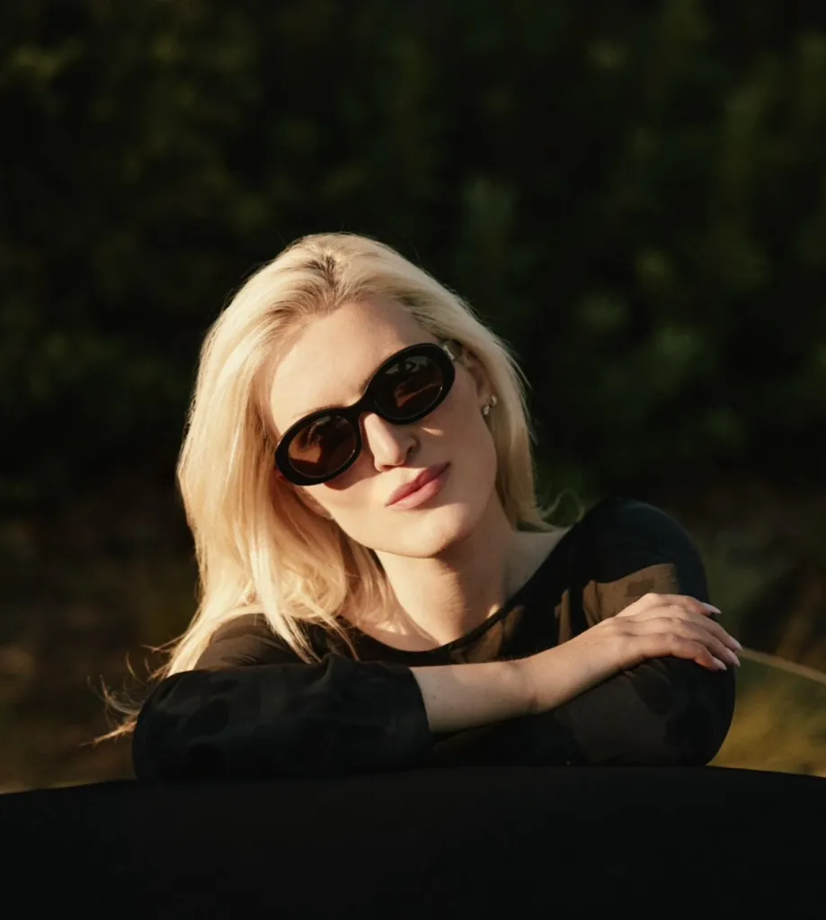 Olivia Nuzzi in sunglasses looking towards the camera.