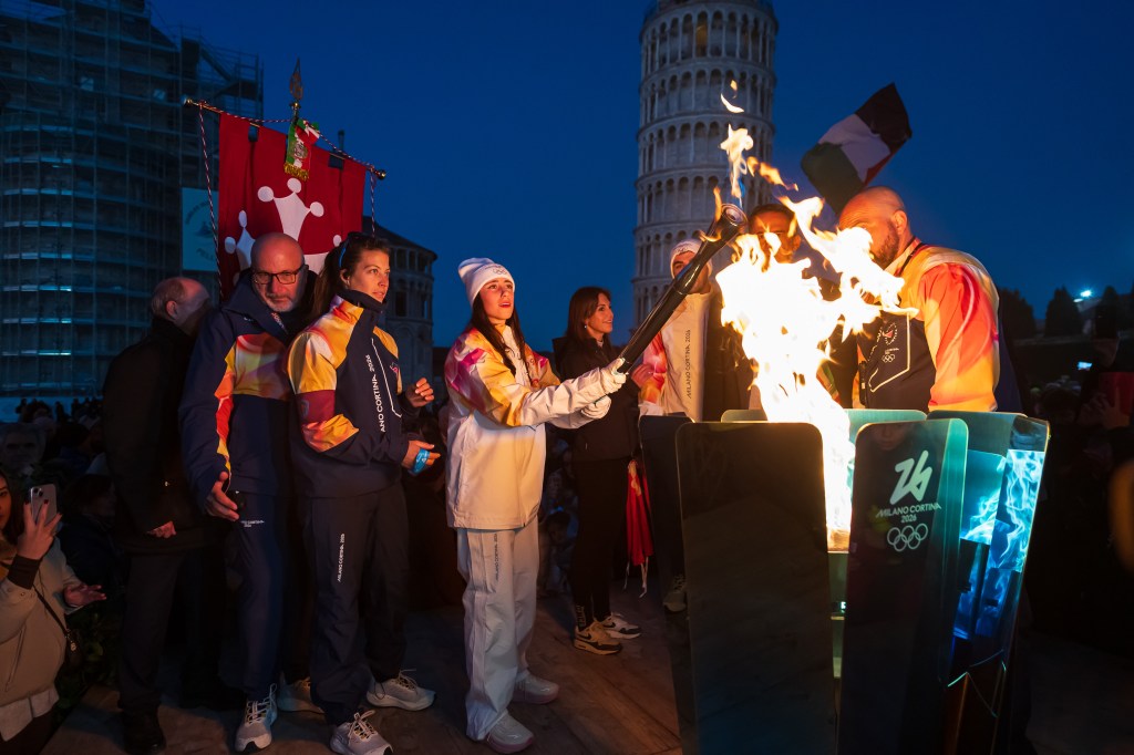 The Olympic Torch for the Milan Cortina 2026 Winter Olympics is lit in Pisa, Italy.