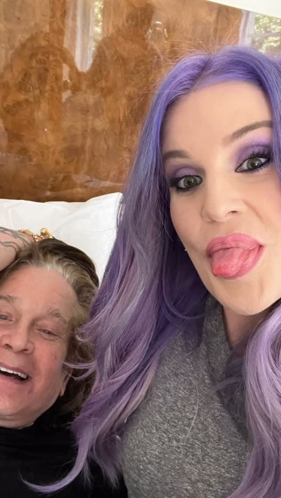 Ozzy Osbourne smiling next to Kelly Osbourne sticking out her tongue.