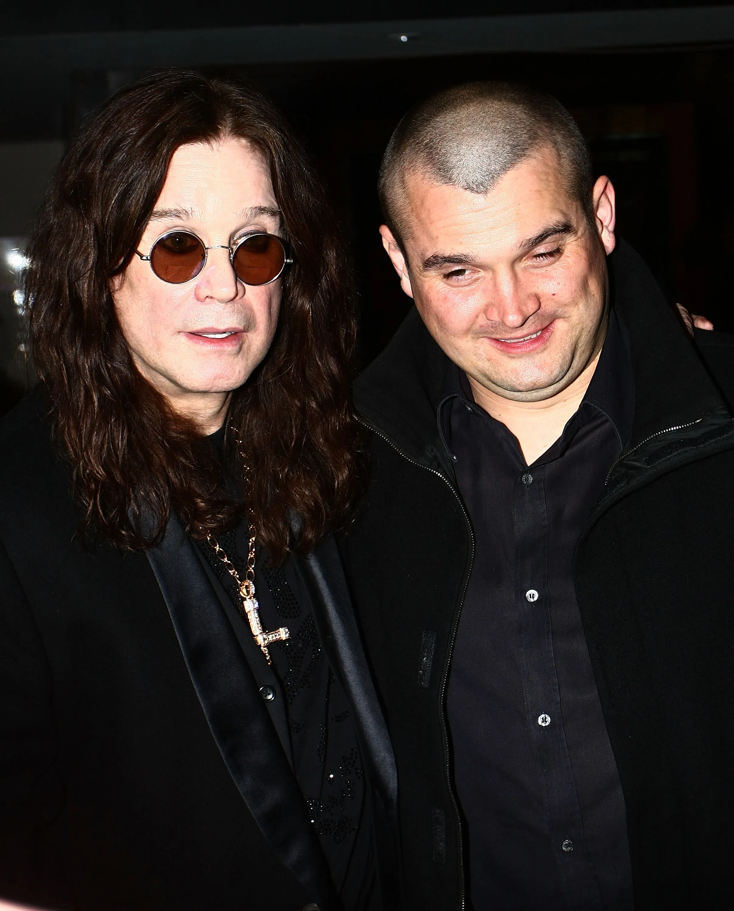 Ozzy Osbourne and his son Louis Osbourne posing for a photo.