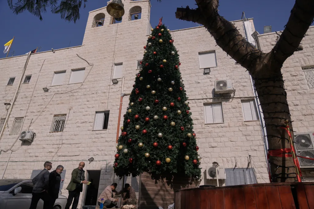 Palestinian parishioners checking a recently installed Christmas tree at the Holy Redeemer Latin Church in Jenin, West Bank.