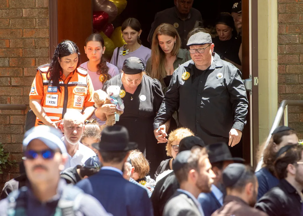 The parents of 10-year-old Matilda leave the funeral at Chevra Kadisha Memorial Hall.