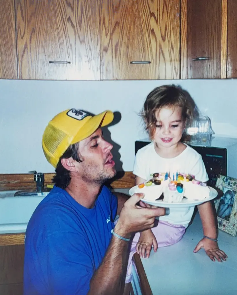 Paul Walker holds a birthday cake for his daughter Meadow.