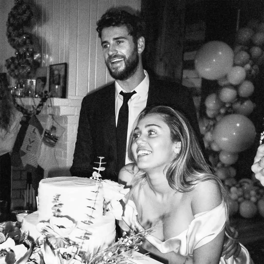 Black and white photo of Miley Cyrus and Liam Hemsworth at their wedding.
