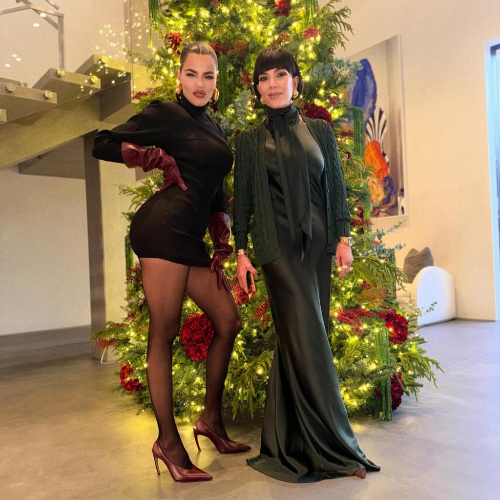 Khloé Kardashian and Kris Jenner posing in front of a Christmas tree.