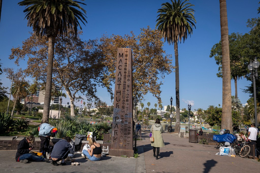 People gather in front of MacArthur Park in Los Angeles.