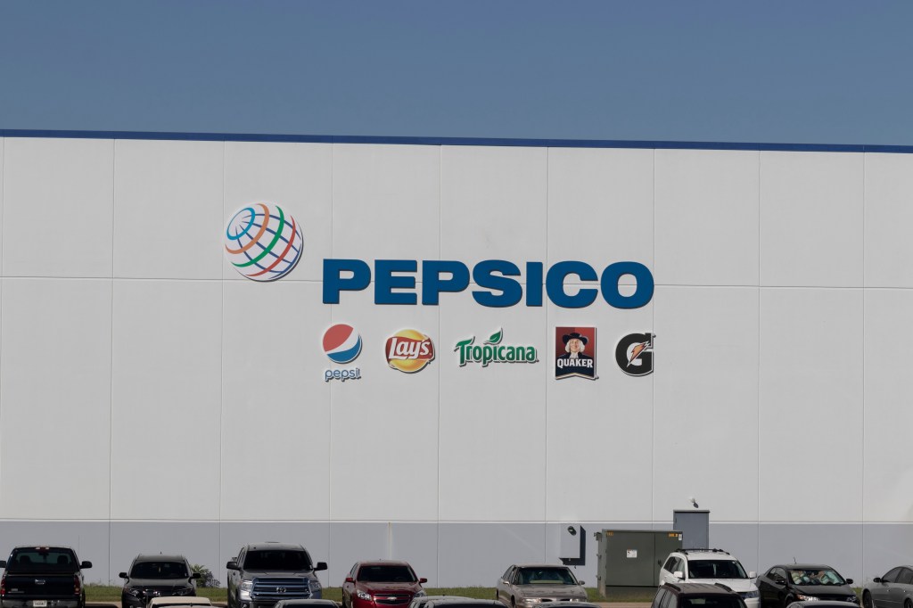 PepsiCo logo on a white building wall with logos of Pepsi, Lay's, Tropicana, Quaker, and Gatorade below it.