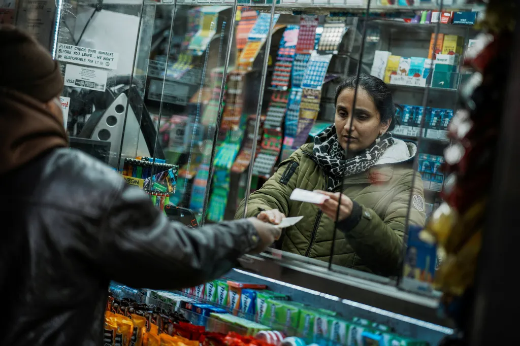 A person buys tickets for the $1.25 billion jackpot in the Powerball lottery drawing in New York City, U.S. December 17, 2025
