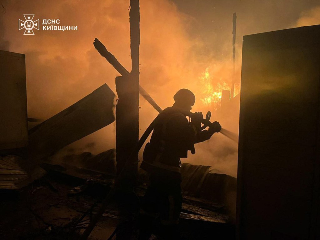 A firefighter battles a blaze at the site of a Russian airstrike in the Kyiv region.