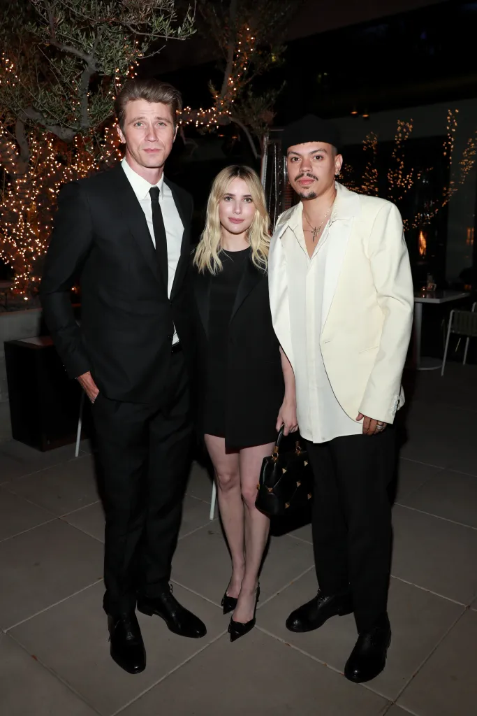 Garrett Hedlund, Emma Roberts, and Evan Ross at an Oscars party.