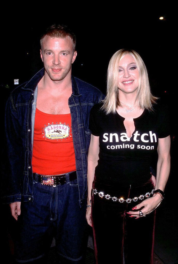 Guy Ritchie in a red tank top and denim, and Madonna in a