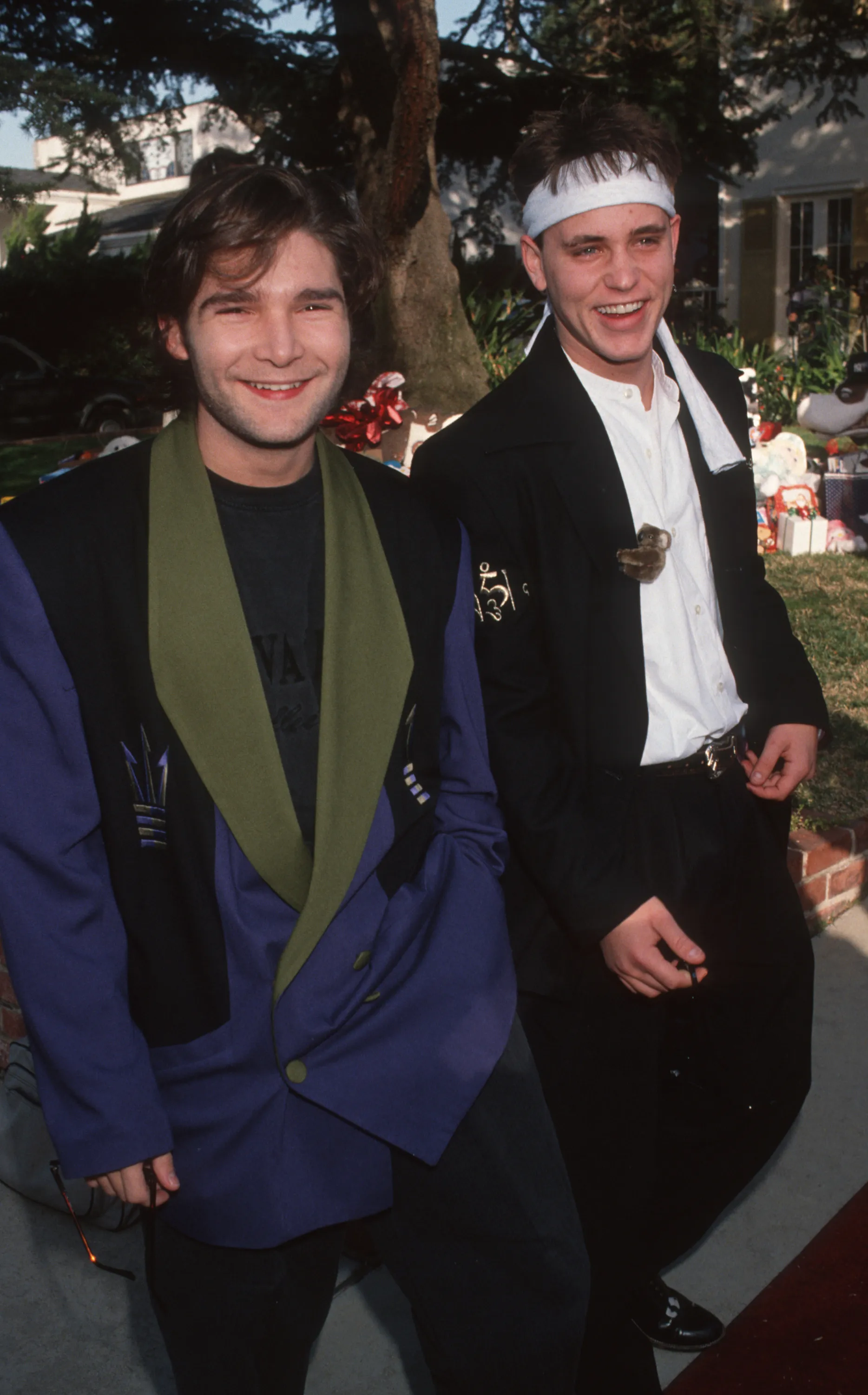 Corey Feldman and Corey Haim smiling.