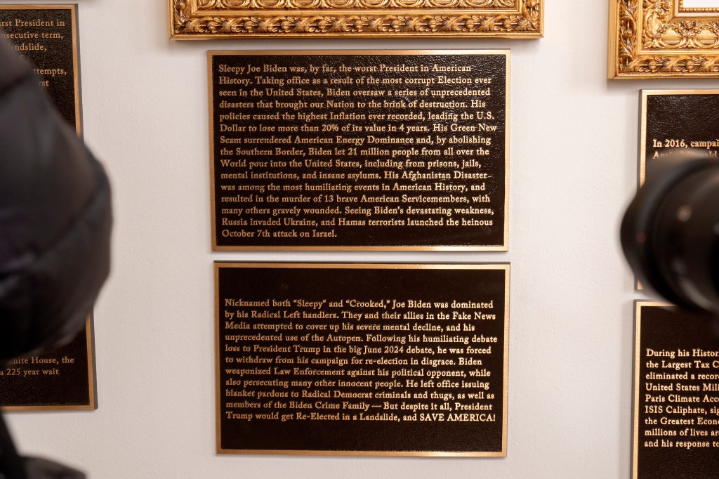 Plaques with derogatory text about Joe Biden and praise for Donald Trump.
