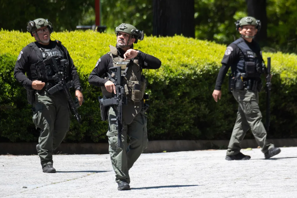 Armed police and emergency workers respond to an active shooter incident in Atlanta.
