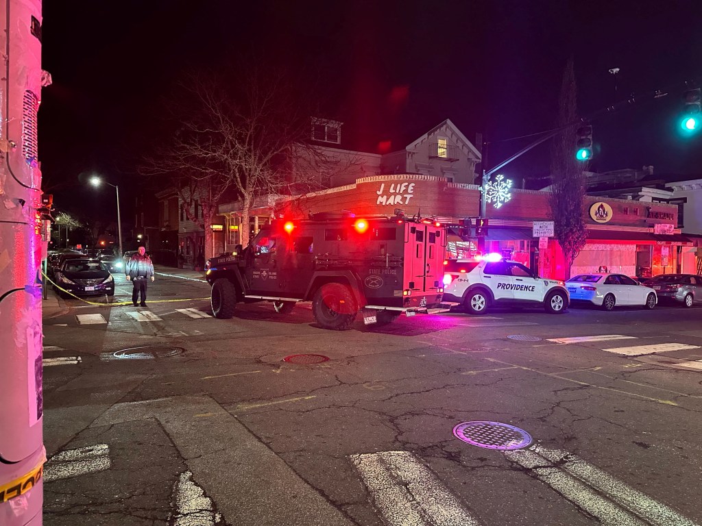 Police vehicles near Brown University in Providence after a shooting incident.