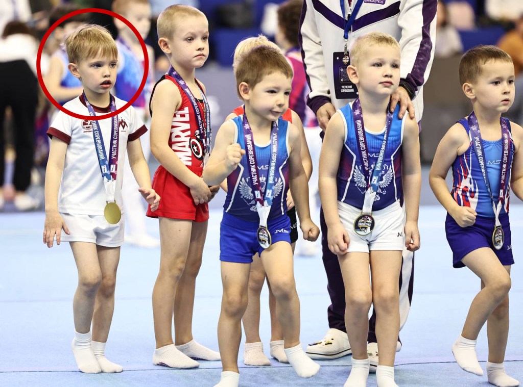 Young male gymnasts, including Spiridonov Ivan (circled), are awarded medals at the Gymnastics League-2024 event.