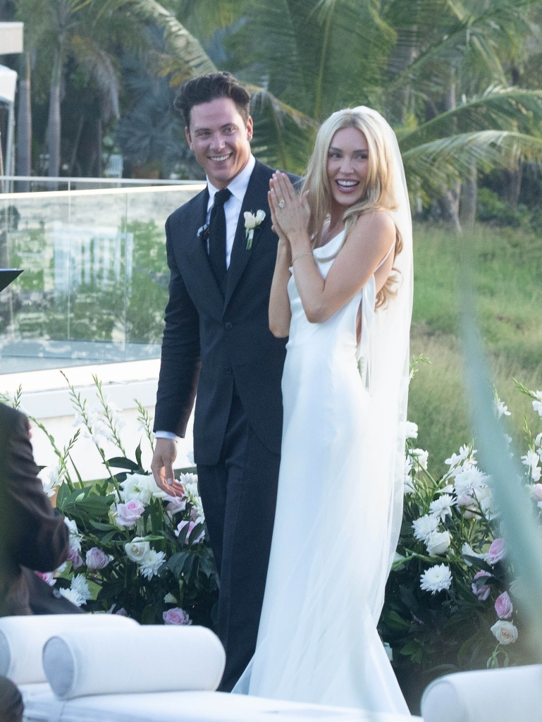 Cassie Randolph and Brighton Reinhardt smiling at their wedding.