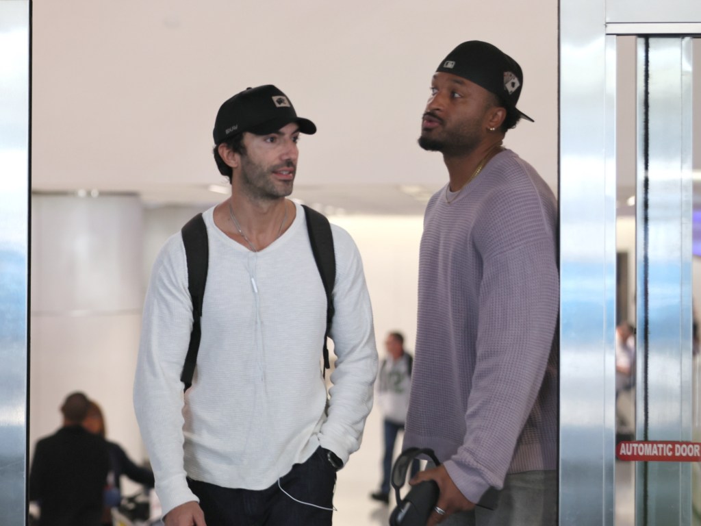 Justin Baldoni talking to BeBe Winans at LAX airport.