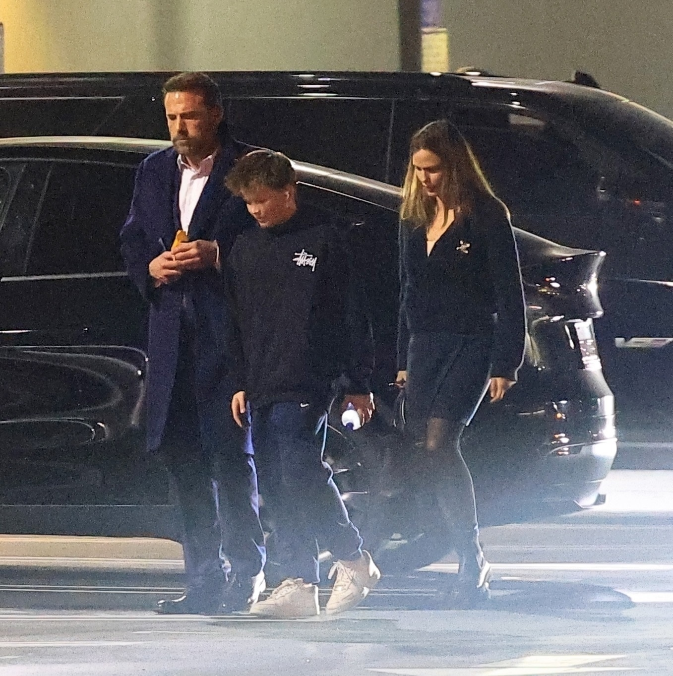 Ben Affleck, Jennifer Garner, and Samuel Affleck walking together.